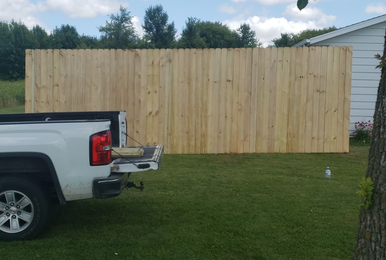 Tall cedar privacy fence installed in a residential yard