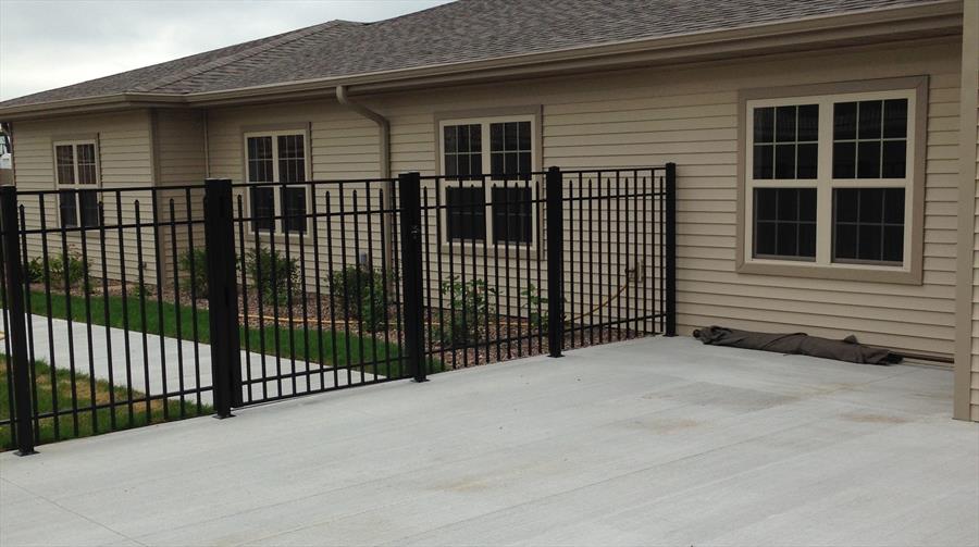 Ornamental fence and gate detail beside a patio