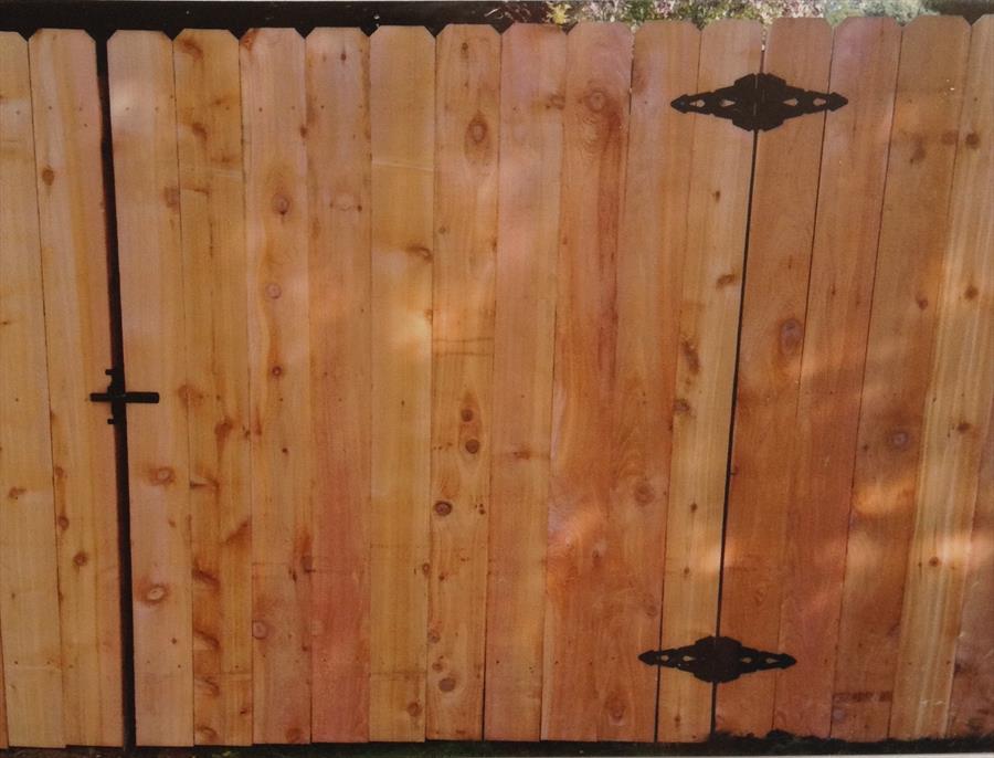 Backyard cedar fence providing separation and a natural wood finish