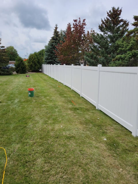 Vinyl fence installation detail at a finished property