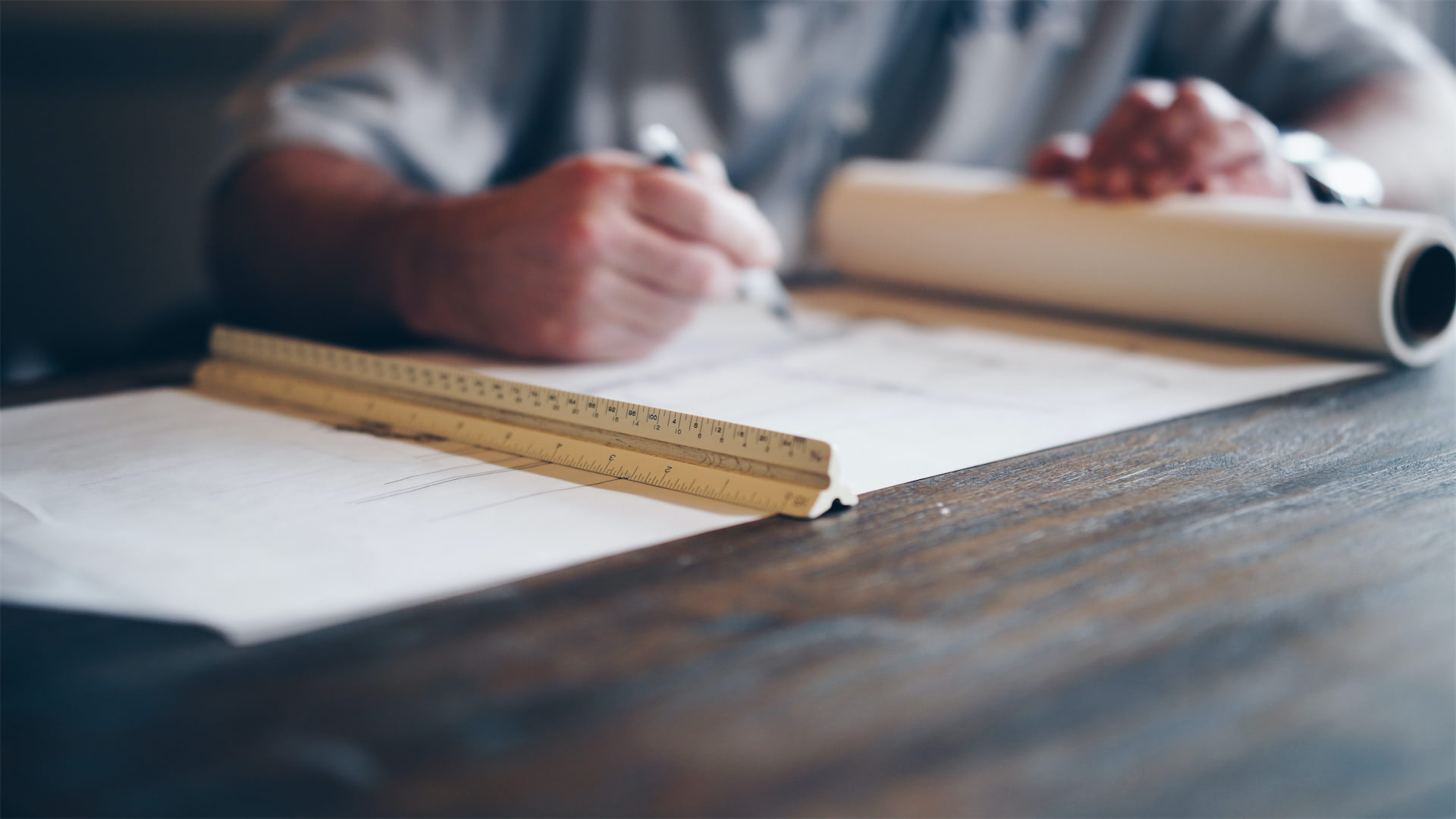 Planning documents and measuring tools used to prepare property maintenance work